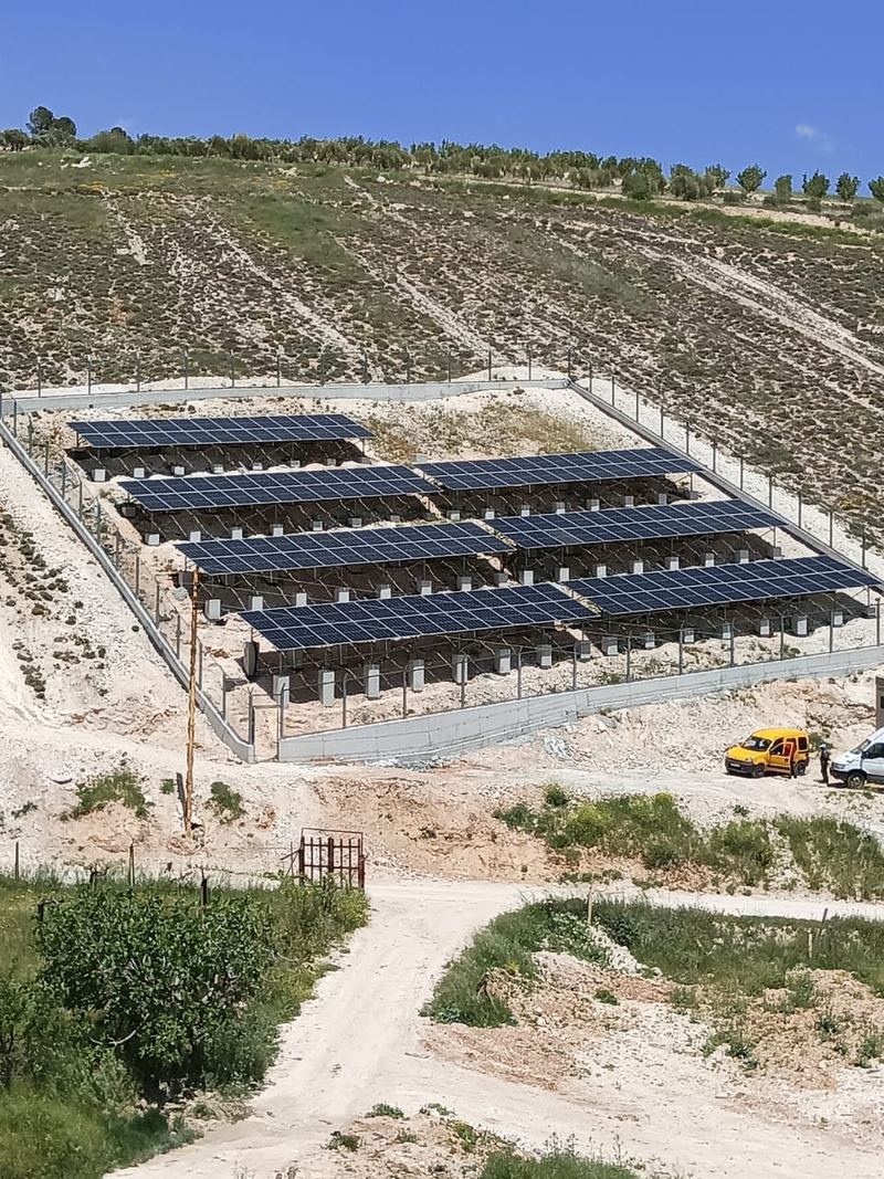 The fenced array on the terraced hillside