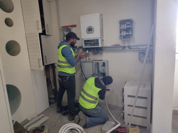 Our team connecting the inverter and protection boxes